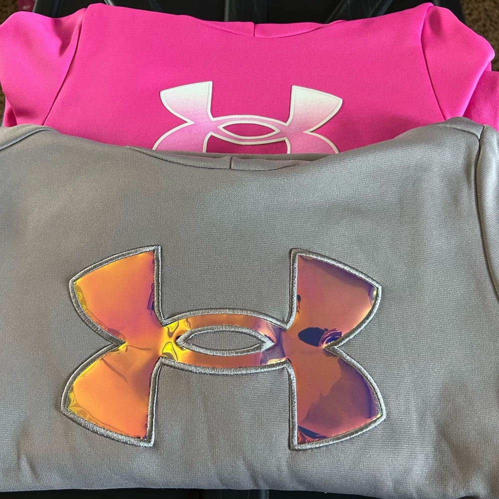 A pair of Under Armour hoodies Gray & Hot Pink.